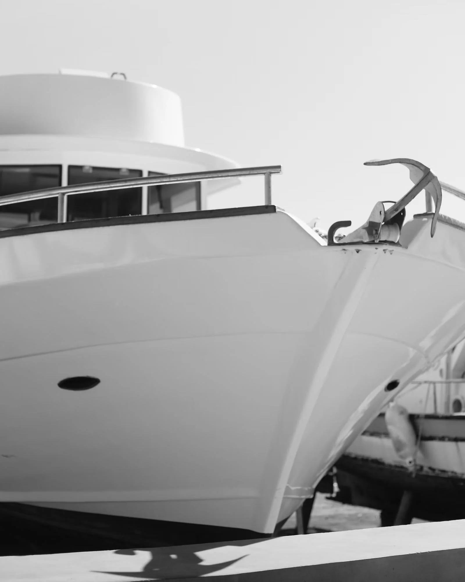 The curved superstructure and rail of a white motor yacht